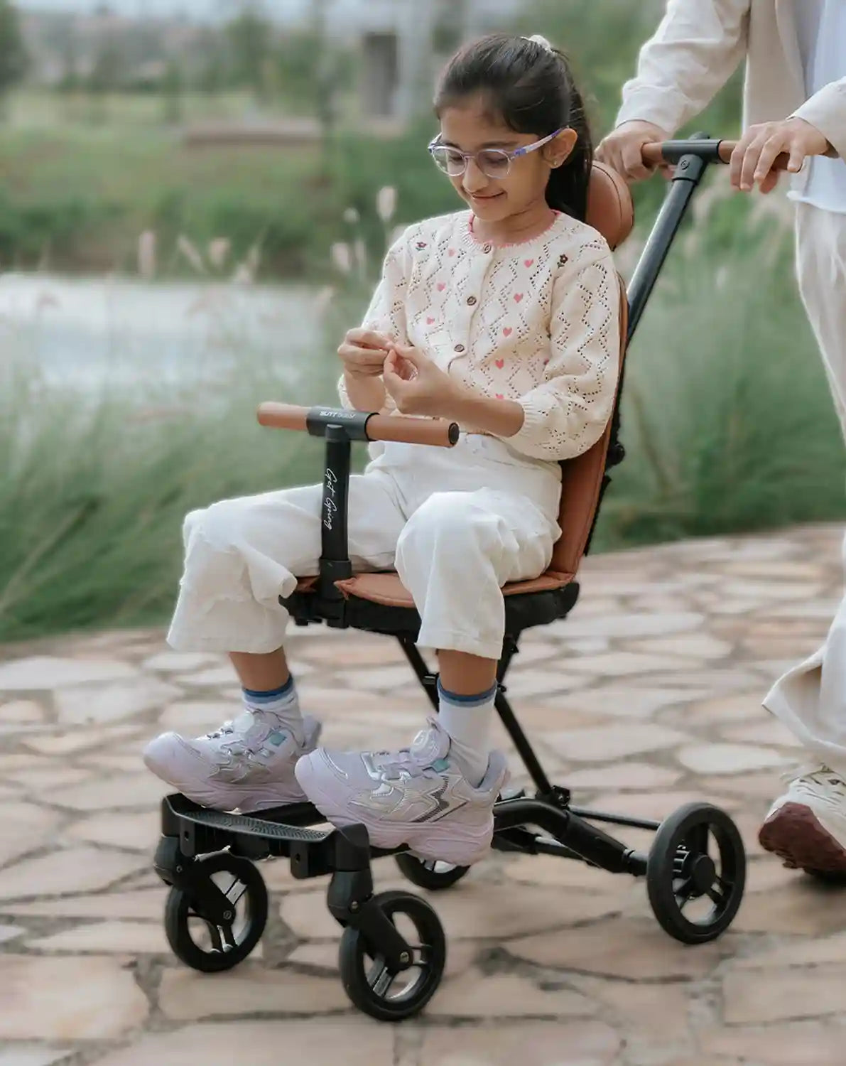 Butt Baby Get Going big kids to small kids travel stroller to scooter in burnt orange, big kids riding